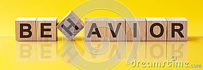 BEHAVIOR Word made of building blocks on a light yellow background Stock Photo