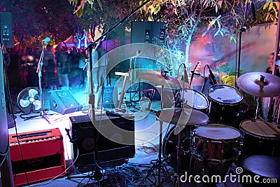 Behind the back line at a gig. Drums, guitar and amps behind microphones front row Editorial Stock Photo