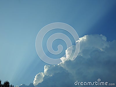 Behind this big cloud of rain and storm, the sun seems to want to return Stock Photo