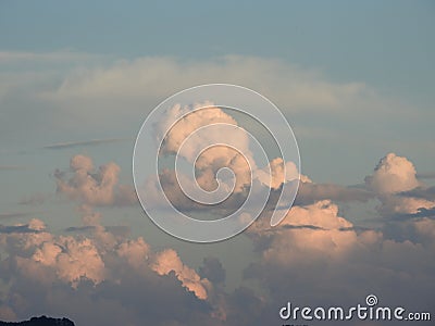 Behind this big cloud of rain and storm, the sun seems to want to return Stock Photo