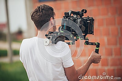 Behind the scene. Cameraman shooting film scene with his camera Stock Photo