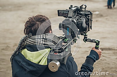 Behind the scene. Cameraman shooting film scene with his camera Stock Photo