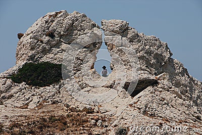 Behind shot of the person on the rocky mountains Stock Photo