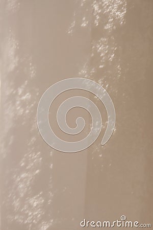 Beige background - light and dark, connected by blurry patterns with the effect of overlaying a layer of intertwining dots. Stock Photo