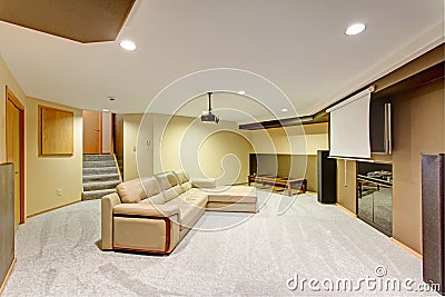 Beige basement movie room with a leather sectional Stock Photo