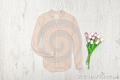 Beige blouse and bouqet of tulips. Fashionable concept Stock Photo