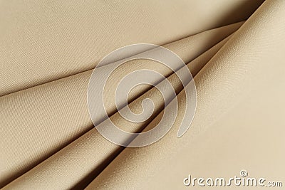 Beige crumpled or wavy fabric texture background. Abstract linen cloth soft waves. Gabardine wool fabric. Merino yarn Stock Photo