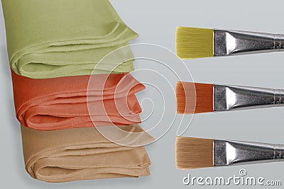 Beige, green, terracotta linen fabric, napkin rolled in several layers, lie on a light background, the concept of natural eco- Stock Photo