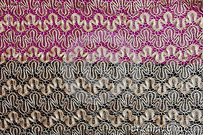 Beige openwork lace on a black-burgundy background Stock Photo