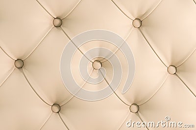 Beige soft tapestry pattern background with symmetrical buttons on the corners of diamonds. Soft and expensive furniture Stock Photo