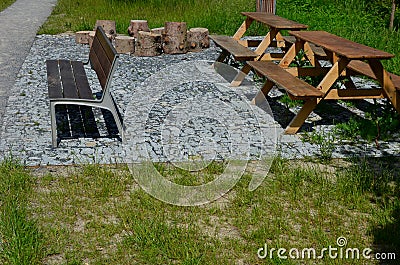 Beige threshing path gravel with delimited edges granite cubes in a row and dividing channels from the cube trough channel due to Stock Photo