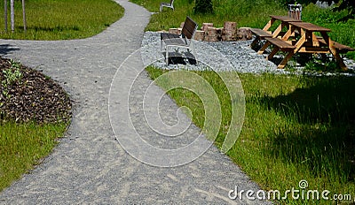 Beige threshing path gravel with delimited edges granite cubes in a row and dividing channels from the cube trough channel due to Stock Photo
