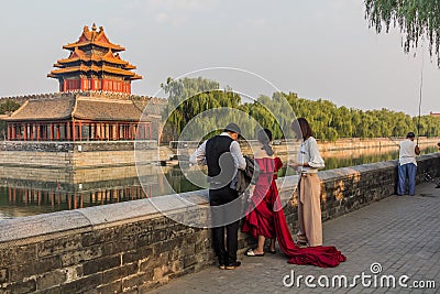 BEIJING, CHINA - AUGUST 28, 2018: Wedding shooting preparation at the Forbidden City moat in Beijing, Chi Editorial Stock Photo