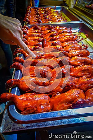 BEIJING, CHINA - 29 JANUARY, 2017: Rows of cooked ducks ready to eat, local chinese food market concept Stock Photo