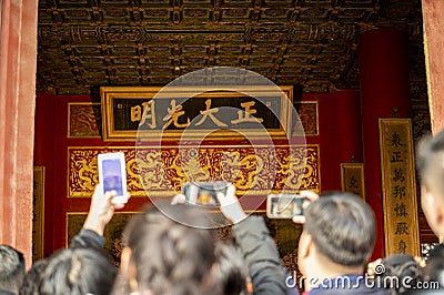 Beijing, China, January 2, 2020 : Tourist crowd take vedeo ancient dragon throne of the Emperor of China at Qianqinggong Palace Editorial Stock Photo