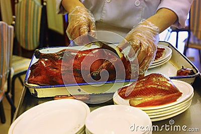 Beijing duck meat being cut off bones Stock Photo