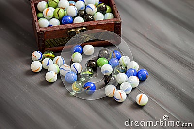 Being a child is playing a marble. The colors are colored marbles, beautiful-looking marbles Stock Photo