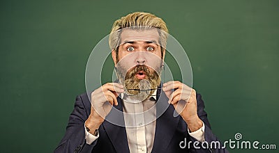 Being open to surprise in classroom. Surprised teacher green chalkboard. Bearded man look surprised. Surprised and Stock Photo