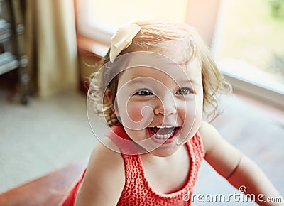 Being young means enjoying days full of fun. an adorable little girl at home. Stock Photo