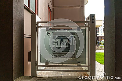 Belarus, Grodno July 20, 2022: A modern entrance of a residential building equipped with a mechanism for lifting a wheelchair. Editorial Stock Photo