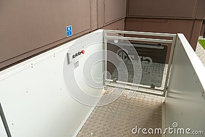 Belarus, Grodno July 20, 2022: A modern entrance of a residential building equipped with a mechanism for lifting a wheelchair. Editorial Stock Photo