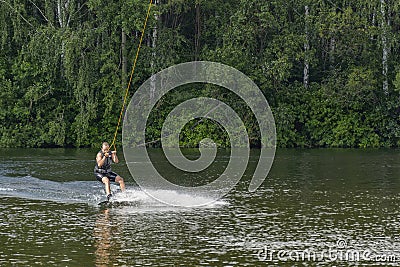 Belarus, Minsk, 07.09.2016: The man trains to balance on the board for kitesurfing Editorial Stock Photo