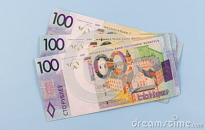 Belarusian money after devaluation. Salary or credit. Nomination one hundred rubles on a blue background Stock Photo