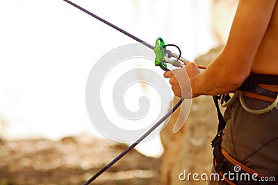 Belayer with the rope and carabines Stock Photo