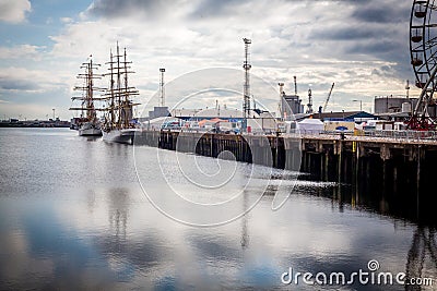 Belfast docks tall ship and Ferris wheel Editorial Stock Photo