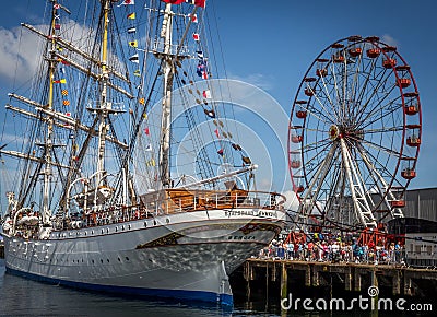 Belfast docks tall ship and Ferris wheel Editorial Stock Photo