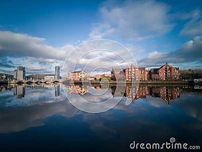 Belfast, Northern Ireland, Houses near Lagan River. Buildings reflection in water. Stock Photo