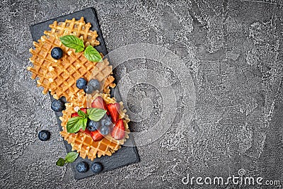 Belgian waffles with fresh berries and caramel sauce Stock Photo