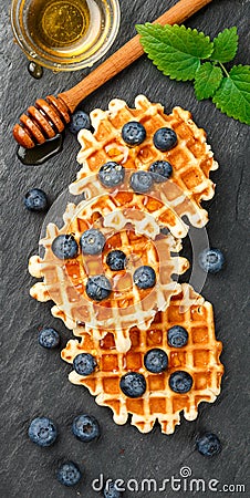 Belgian waffles with honey and fresh berries blueberry and mint Stock Photo