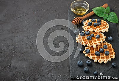 Belgian waffles with honey and fresh berries blueberry and mint Stock Photo