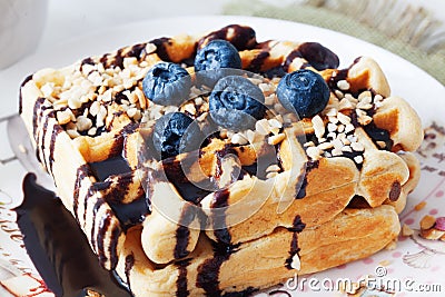 Belgian waffles with peanut chocolate sauce and blueberry, bilberry, whortleberry, huckleberry, hurtleberry, blaeberry Stock Photo