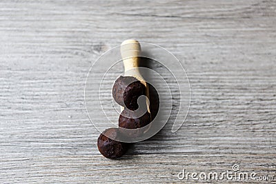 Belgium chocolate candy in wooden spoon Stock Photo