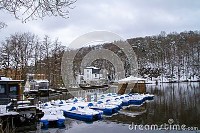 Belgium, Spa, View of Lake Warfaaz under the snow with its pedal boats Editorial Stock Photo