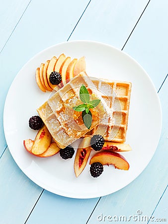 Belgium waffles with fruits and honey Stock Photo