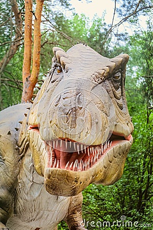 Tyrannosaur head - robotic dinosaur exhibit. Portrait of a sharp-toothed predatory dinosaur. Belgorod dinopark. Editorial Stock Photo