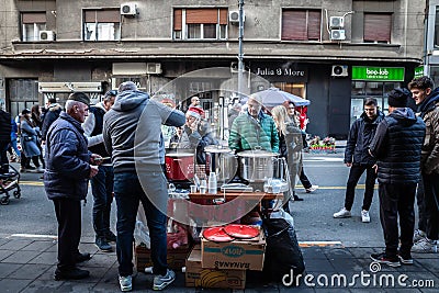 BELGRADE, SERBIA - JANUARY 1, 2023: Man selling boiled and grilled corn in a Crowded street of Svetogorska ulica on open heart Editorial Stock Photo