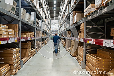 Belgrade, Serbia - January 02, 2023: Warehouse aisle in an IKEA store. Man walking i IKEA furniture warehouse area Editorial Stock Photo