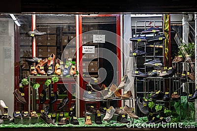 BELGRADE, SERBIA - JULY 16, 2023: Selective blur on the window of a vintage old shoe store at night, in a decaying environment, in Editorial Stock Photo