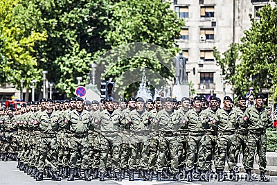 Rows of military troop marching on streets during sunny summer day Editorial Stock Photo