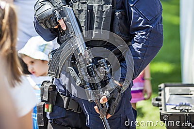 Armed policeman holding a rifle dressed in his uniform Editorial Stock Photo