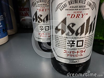 Logo of Asahi breweries on bottles of beer for sale. Editorial Stock Photo