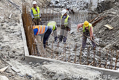 Construction workers laying foundations Editorial Stock Photo