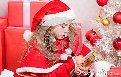 Believe in miracle. Send letter for santa. Wish list. Child santa costume enjoy christmas eve. Child write letter to Stock Photo