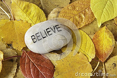 Believe Rock with Fall Leaves Stock Photo