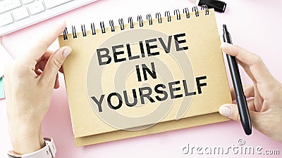 Believe In Yourself written on an yellow sticky note on a cork Stock Photo