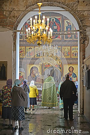 The believers people stand on church service in Church of the Assumption. Poshekhonje, Yaroslavl region Editorial Stock Photo